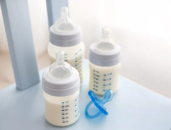 Baby milk bottles and pacifier — Stock Photo, Image