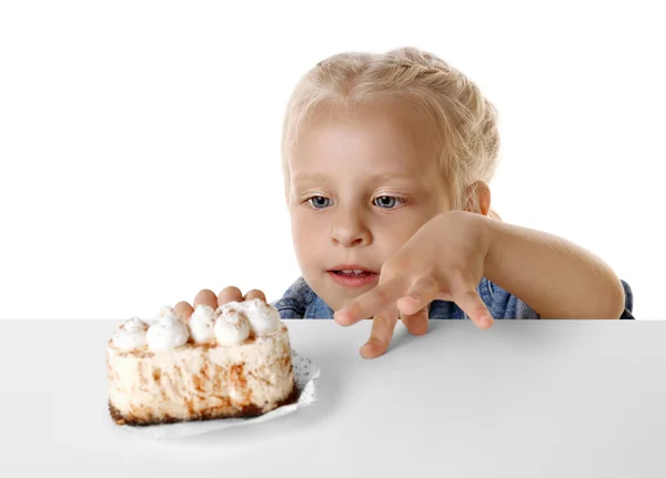 Funny little girl looking at cake — Stock Photo, Image