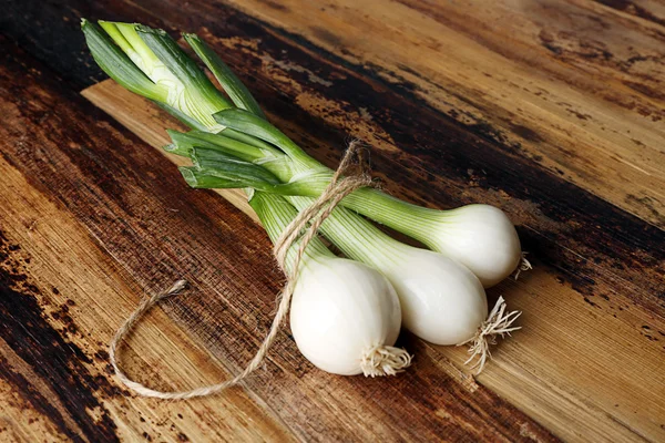 Tied bunch of onions — Stock Photo, Image