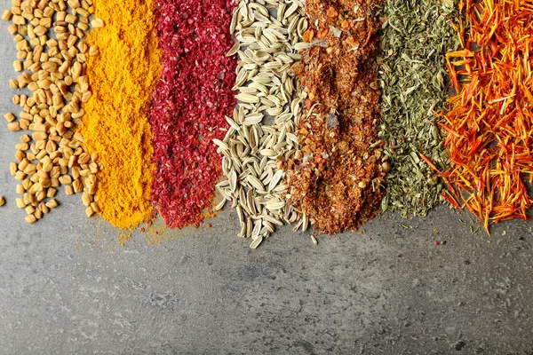 Different spices on gray — Stock Photo, Image