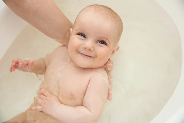 Cute baby bathing Stock Image