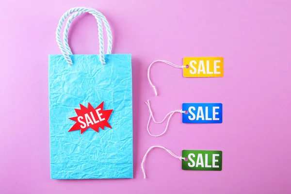 Paper bag with tags and word sale — Stock Photo, Image