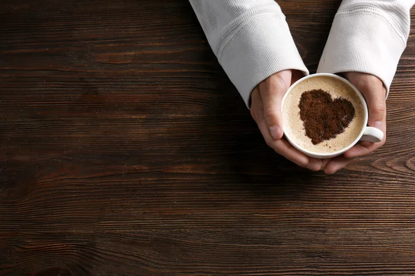 Man holding in hands cup of coffee