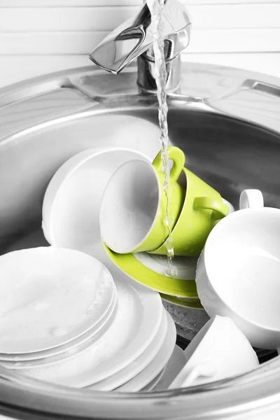 Pile of dishes in sink — Stock Photo, Image