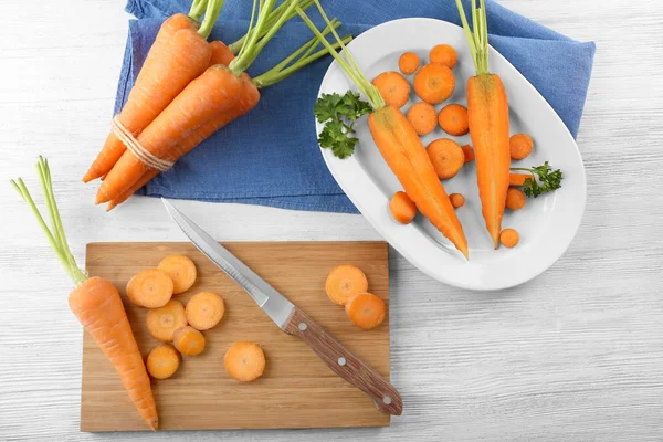 Fresh carrots on cutting board — Stock Photo, Image