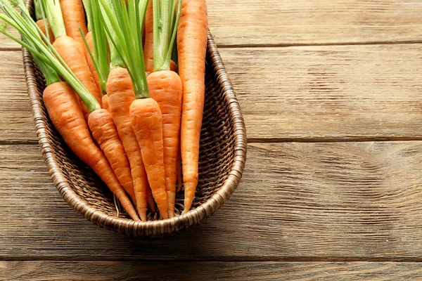 Carrots in wicker bowl — Stock Photo, Image