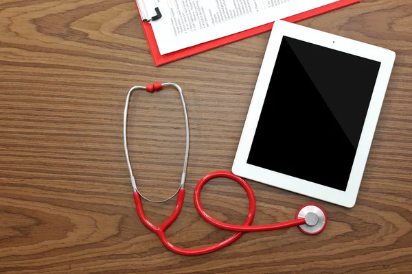 Red stethoscope on table — Stock Photo, Image