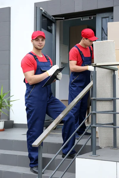 Два рабочих-мужчины с тяжелыми коробками — стоковое фото