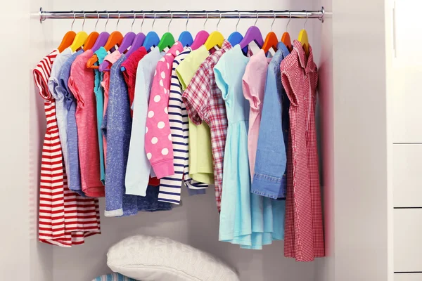 Children clothes hanging on hangers — Stock Photo, Image