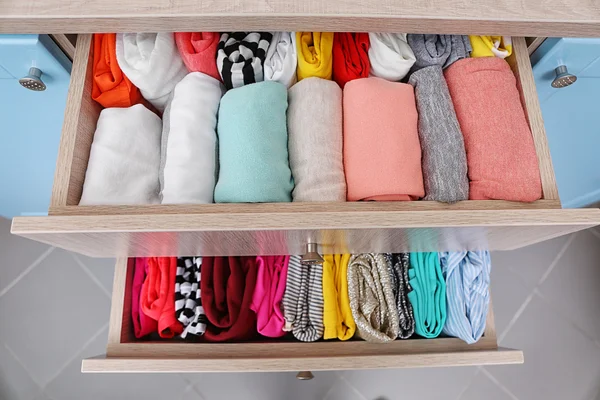 Folded clothes in chest — Stock Photo, Image