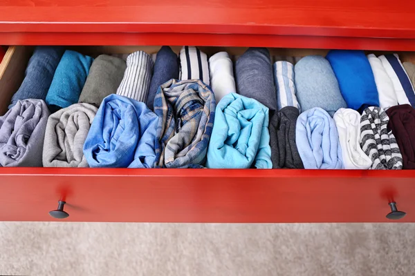 folded clothes in chest