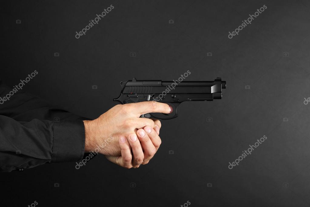 Man S Hands Holding Gun Stock Photo Image By C Belchonock