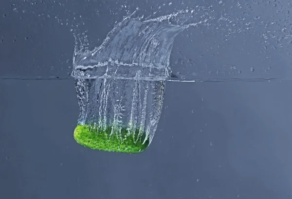 Cucumber falling in water — Stock Photo, Image