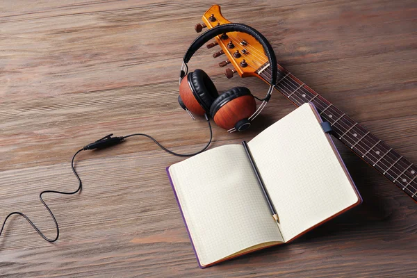 Headphones, guitar and notebook — Stock Photo, Image