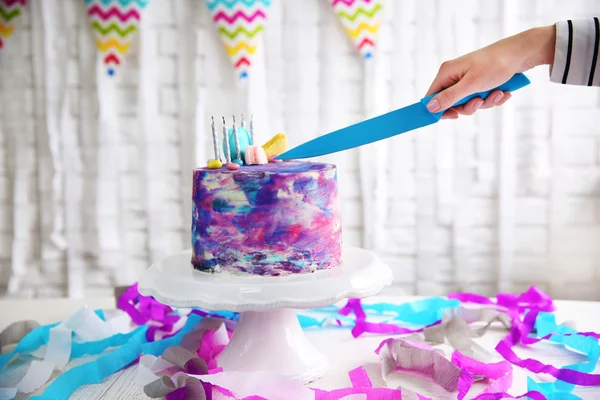 Female hand cutting festive cake — Stock Photo, Image