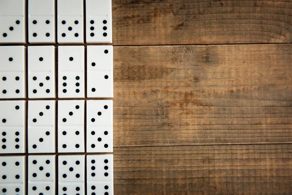 Dominoes on wooden table — Stock Photo, Image