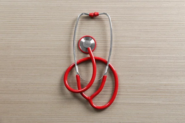 Red stethoscope on table — Stock Photo, Image