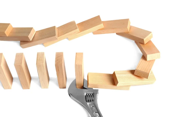 Dominoes row with wrench — Stock Photo, Image