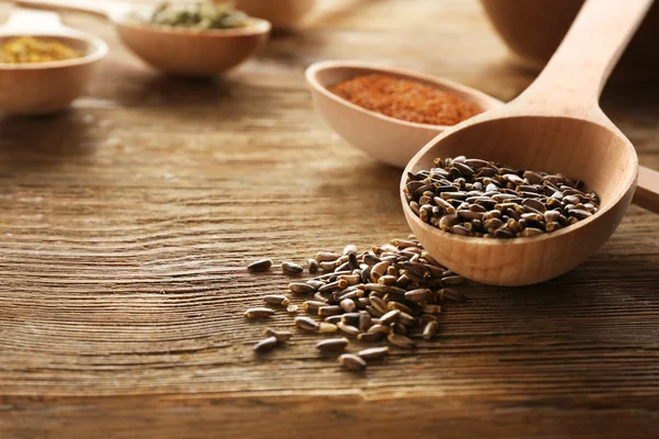 Healing seeds in spoons — Stock Photo, Image