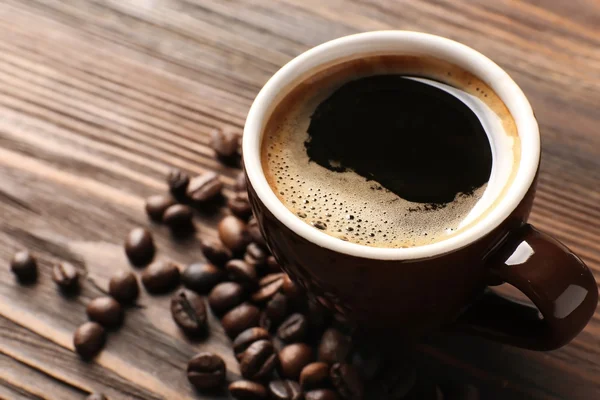 Cup of coffee with beans — Stock Photo, Image