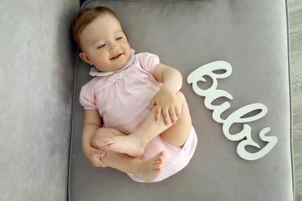 Baby laying on sofa — Stock Photo, Image