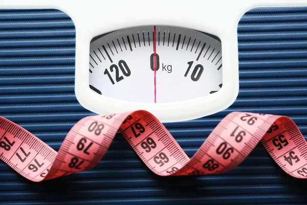 Bathroom scale with measuring tape — Stock Photo, Image