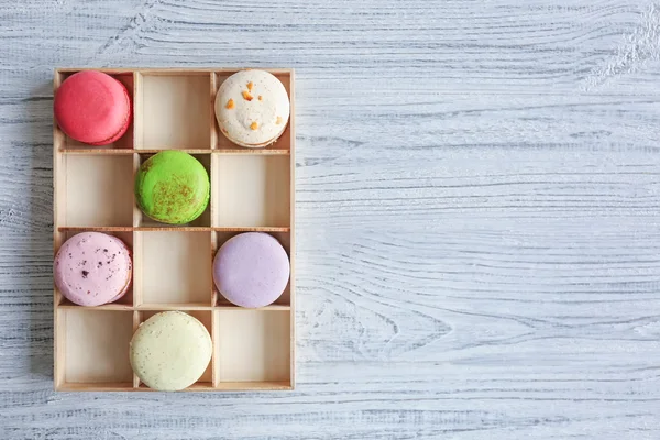 Colorful tasty macaroons in wooden box — Stock Photo, Image
