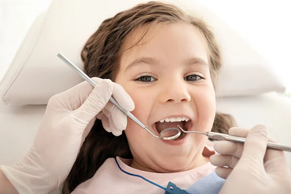 Dentista examinando os dentes da menina — Fotografia de Stock