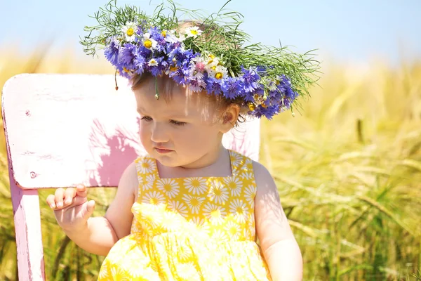 Baby girl with wildflower wreath — Stock Photo, Image