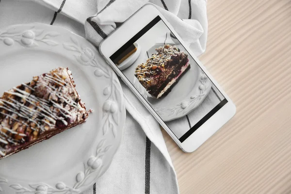 Мобильный телефон с шоколадным тортом — стоковое фото