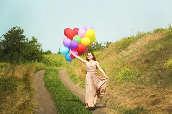 Mujer con globos de colores — Foto de Stock