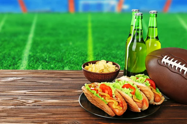 Snacks on football field background — Stock Photo, Image