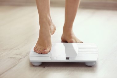 leg stepping on scales clipart