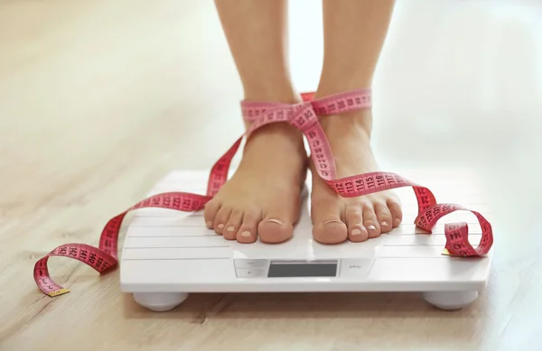 Legs standing on scales — Stock Photo, Image