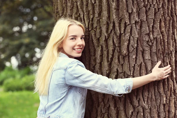 Vrouw knuffelen grote boom — Stockfoto