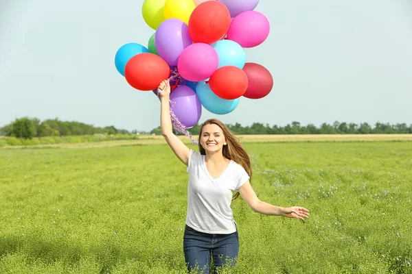 Happy woman with colorful balloons — Stock Photo, Image