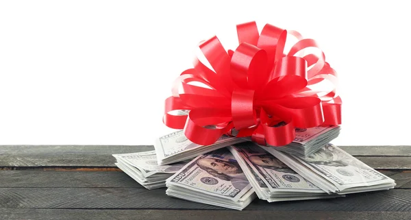 Pile of dollars with bow as gift — Stock Photo, Image