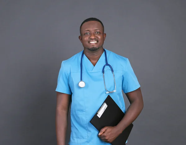 Professional African doctor with clipboard — Stock Photo, Image