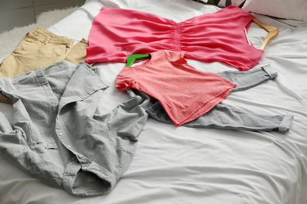 Family clothes on bed