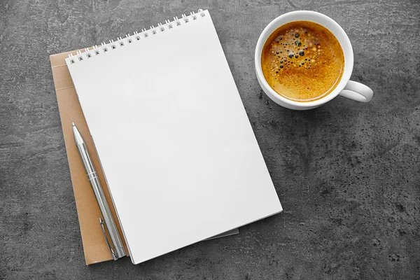 Notitieblok voor leerling met koffie op tafel — Stockfoto