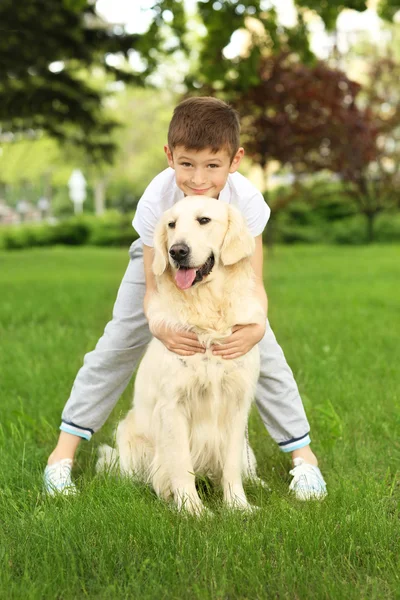 Kleine jongen en hond in park — Stockfoto