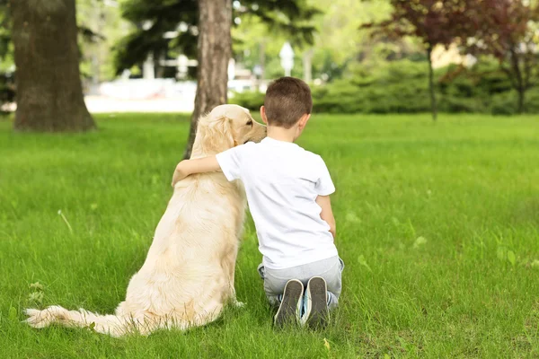 Kleine jongen en hond in park — Stockfoto