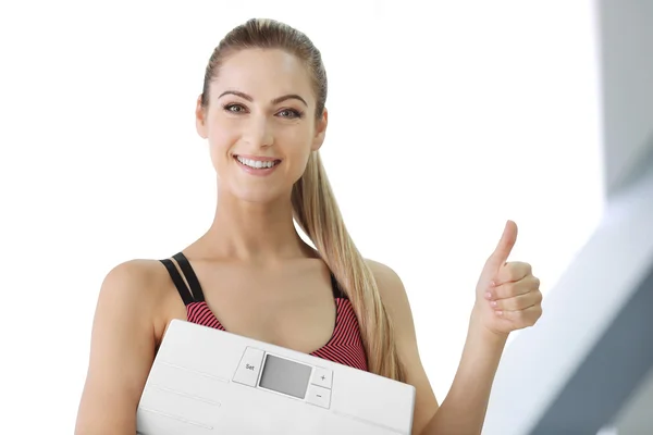 Woman holding floor scales — Stock Photo, Image