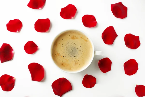 Red rose petals with cup of coffee