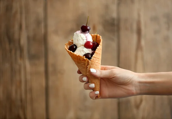 hand holding cherry ice-cream