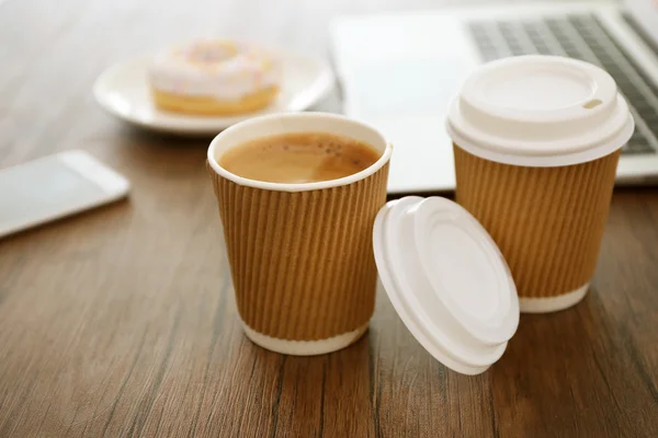 Paper cups of coffee on wooden table — Stock Photo, Image