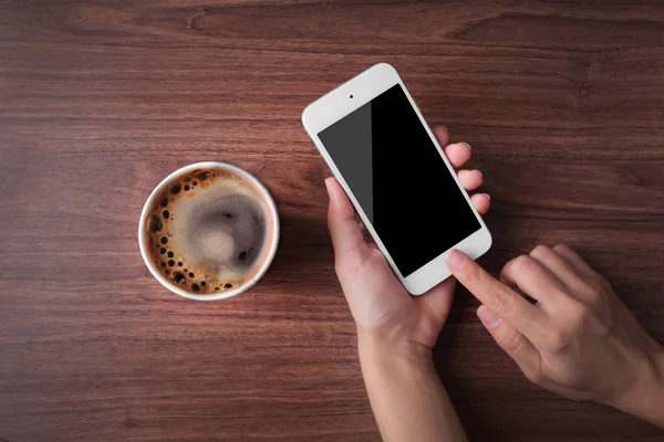 Mãos com telefone celular e xícara de café — Fotografia de Stock