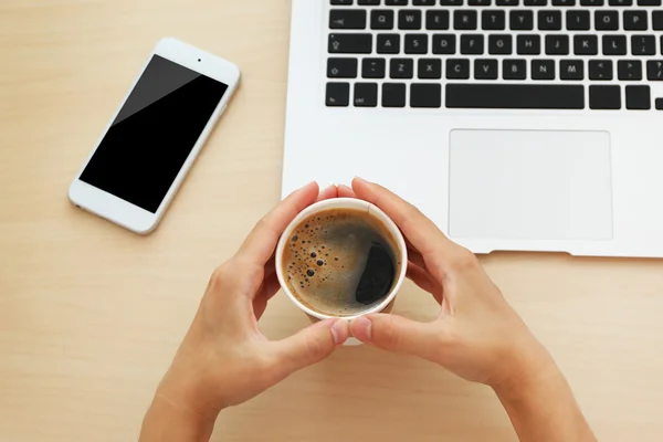 Hands with laptop, phone and cup of coffee — Stock Photo, Image