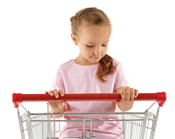 Cute girl sitting in shopping cart — Stock Photo, Image