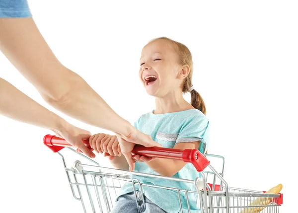 Cute girl sitting in shopping cart — Stock Photo, Image